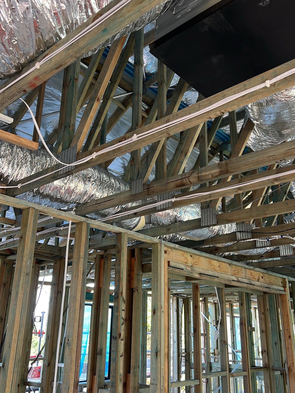 Flexible air conditioning ducts lying unsupported instead of suspended, found during a lock-up inspection in Castle Hill