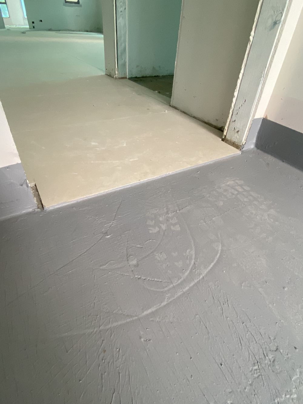 Laundry doorway without the water stop angle wet areas require, found during a waterproofing inspection in Kellyville