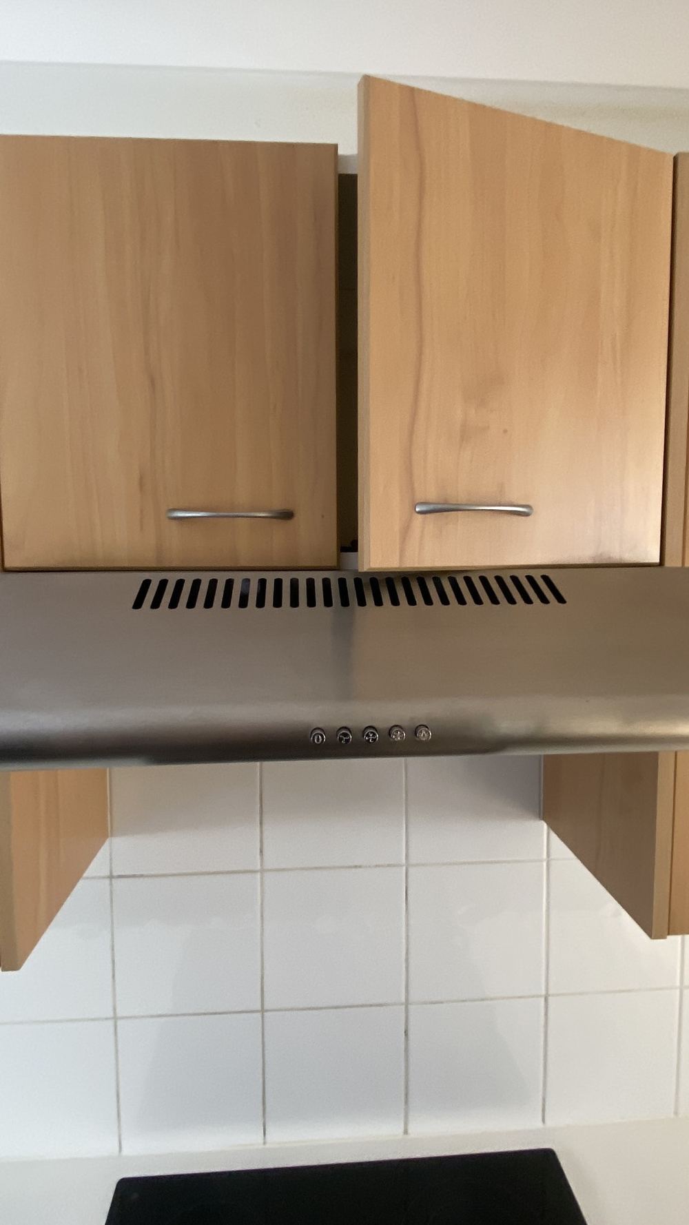 Rangehood venting into the cabinet and staining the wall beside it, found during a pre-purchase building and pest inspection in Castle Hill